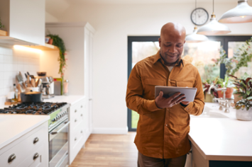 A Veteran on his tablet at home accessing the internet