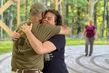 A Veteran hugging his family member outside