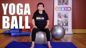 A woman sitting on a yoga ball. 
