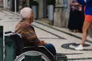 An elderly man sitting in a wheelchair