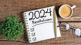 a pad on a table with the words "2024 resolutions"