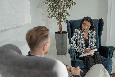 Therapist talking with client in office