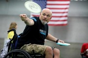 Veteran in wheelchair throwing frisbee
