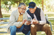 Two elder Veterans looking at a cell phone