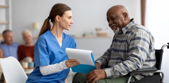 nurse talking to a Veteran in a wheelchair