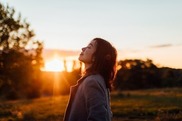 Woman basking in sunrise