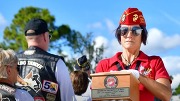 A female marine holding an urn.