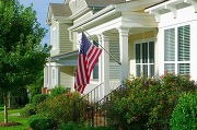 Picture of a house with an American flag hanging in front of it