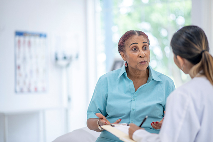 A woman speaks with a doctor.