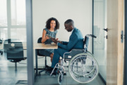 Veteran in Wheelchair talking with woman