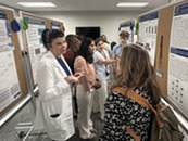 medical professionals viewing research posters