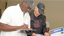 Two Veterans filling out forms image.
