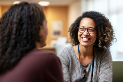Woman smiling in therapy meeting.