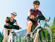 Senior couple biking in the mountains together.