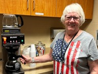 person in front of coffee pot