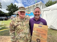 two people holding an award