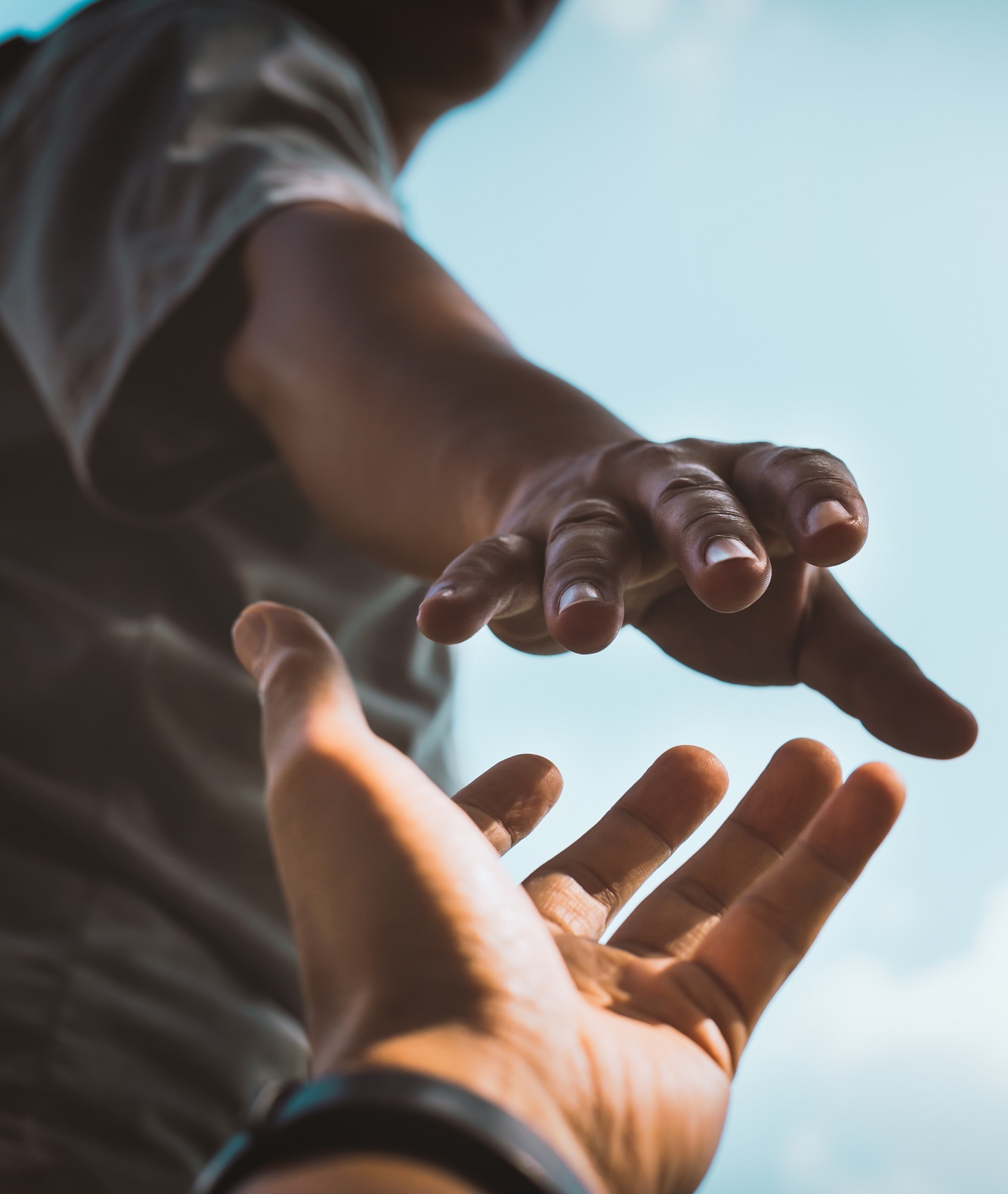 A person extends their hand towards another, symbolizing connection and support in their interaction.