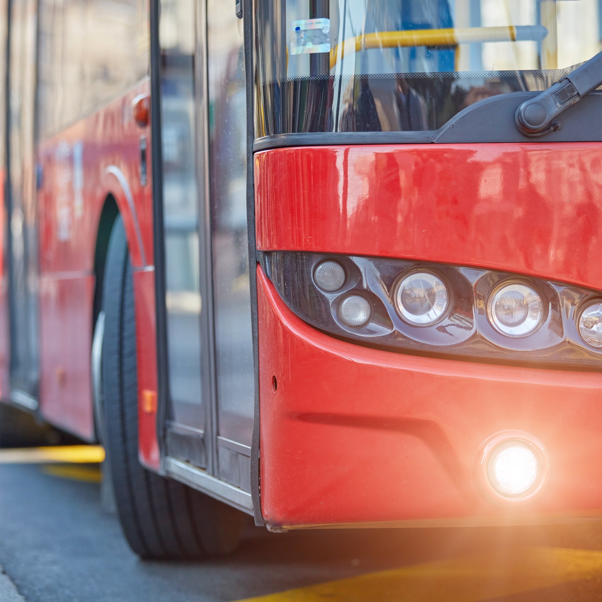 A red bus is parked by the road