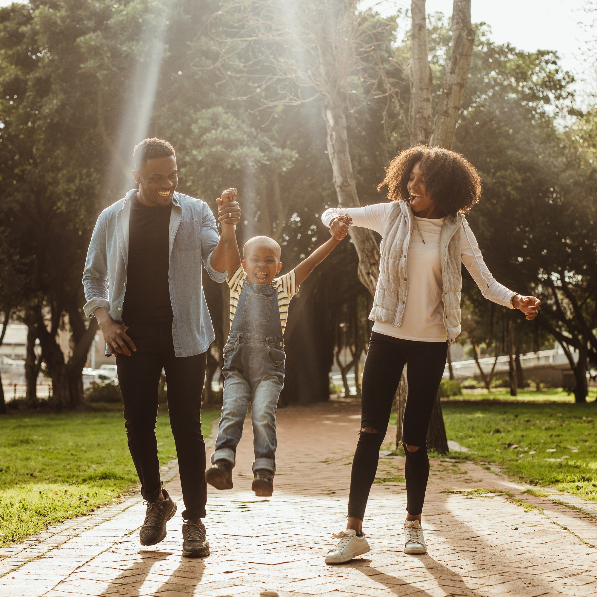 A cheerful family engaging in fun activities at the park, surrounded by greenery and laughter.