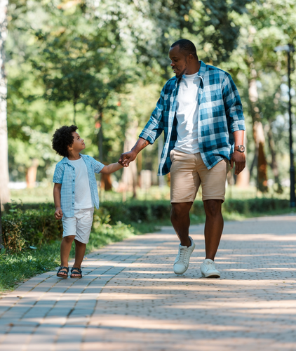 Father and son walking holding hands