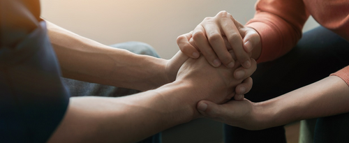 Supportive hands holding eachother