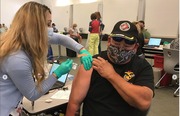 VA nurse administering flu shot to a Veteran. 