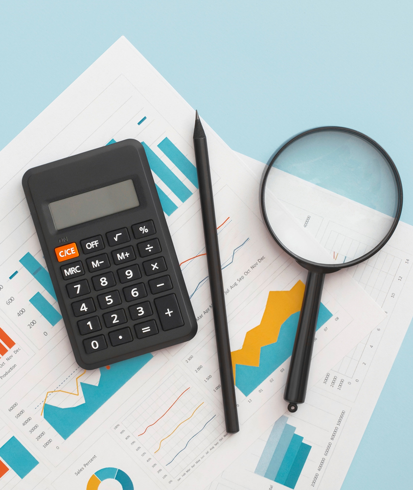 Top down view of a surface with money management items and charts