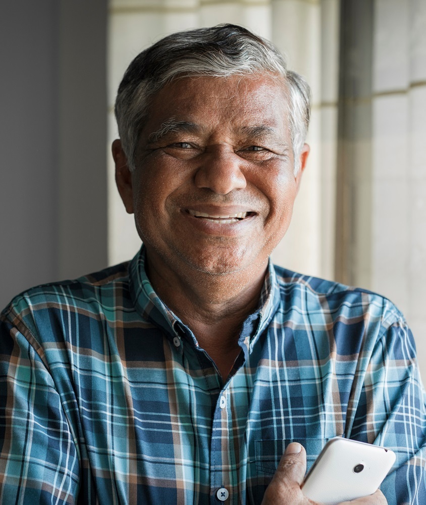 Photo of a smiling Veteran accessing the framework via a celular phone