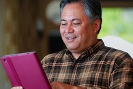 A person enters information on a tablet.