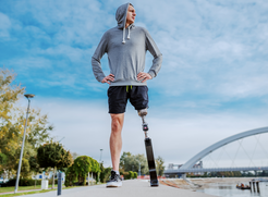 Handicapped man in sportswear and with artificial leg.