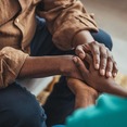 Close up of people clasping hands