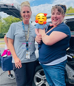 Makyla Clark and a Veteran holding her baby.