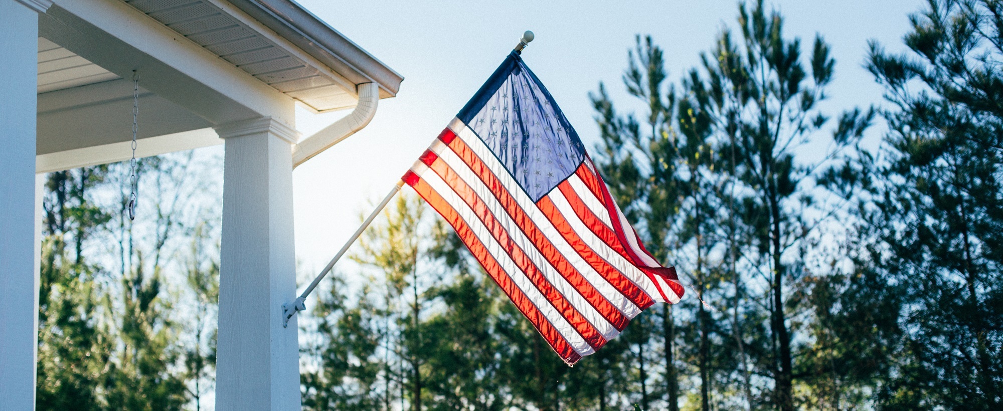 American flag attached to the side of a home=