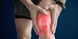 Man touching arthritis knee at pain point.