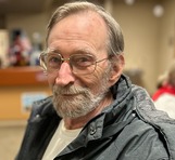 man sitting and smiling