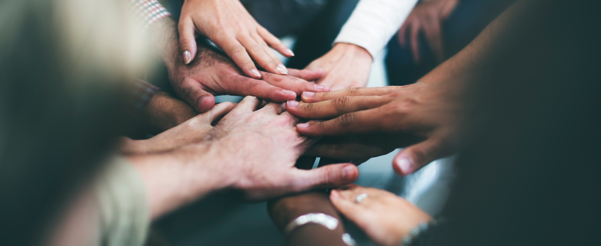 Diverse hands gathering together