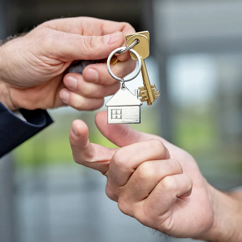 House keys being passed between two hands