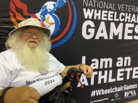 person in wheelchair smiling 