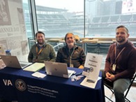 three people sitting at desk 