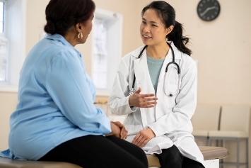 A person speaks with a medical professional