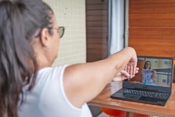 A person speaks with a doctor via a video appointment.