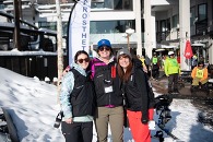 three people in skiing gear smiling