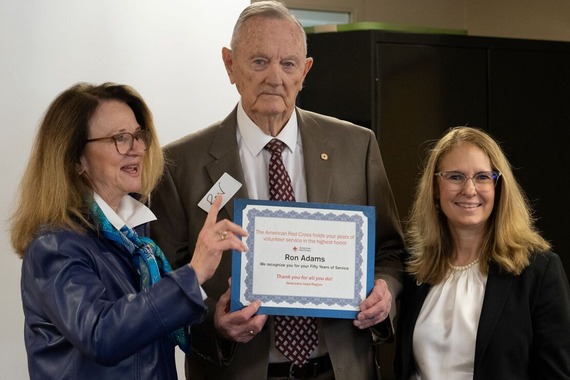 Volunteer Ron Adams poses with Red Cross of Nebraska staff as they award him for 50 years of service. 