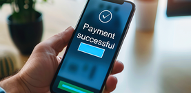 Person holding smartphone with "Payment Successful" screen.