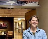 person smiling in front of medical ward