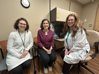 three people sitting in doctors office