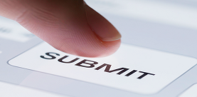 Finger clicking submit button on a form on a tablet.