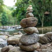 Stones stacked by a stream