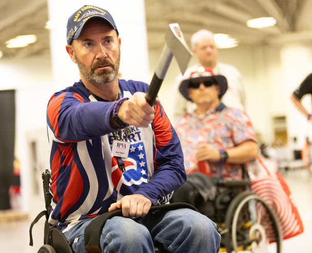 person in wheelchair axe throwing