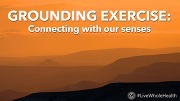 Sunset over layered mountain silhouettes with text: Grounding exercises and connecting with senses.